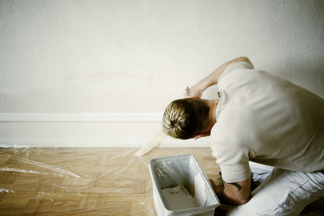 Interior House Painter doing edge work on the trim of the wall